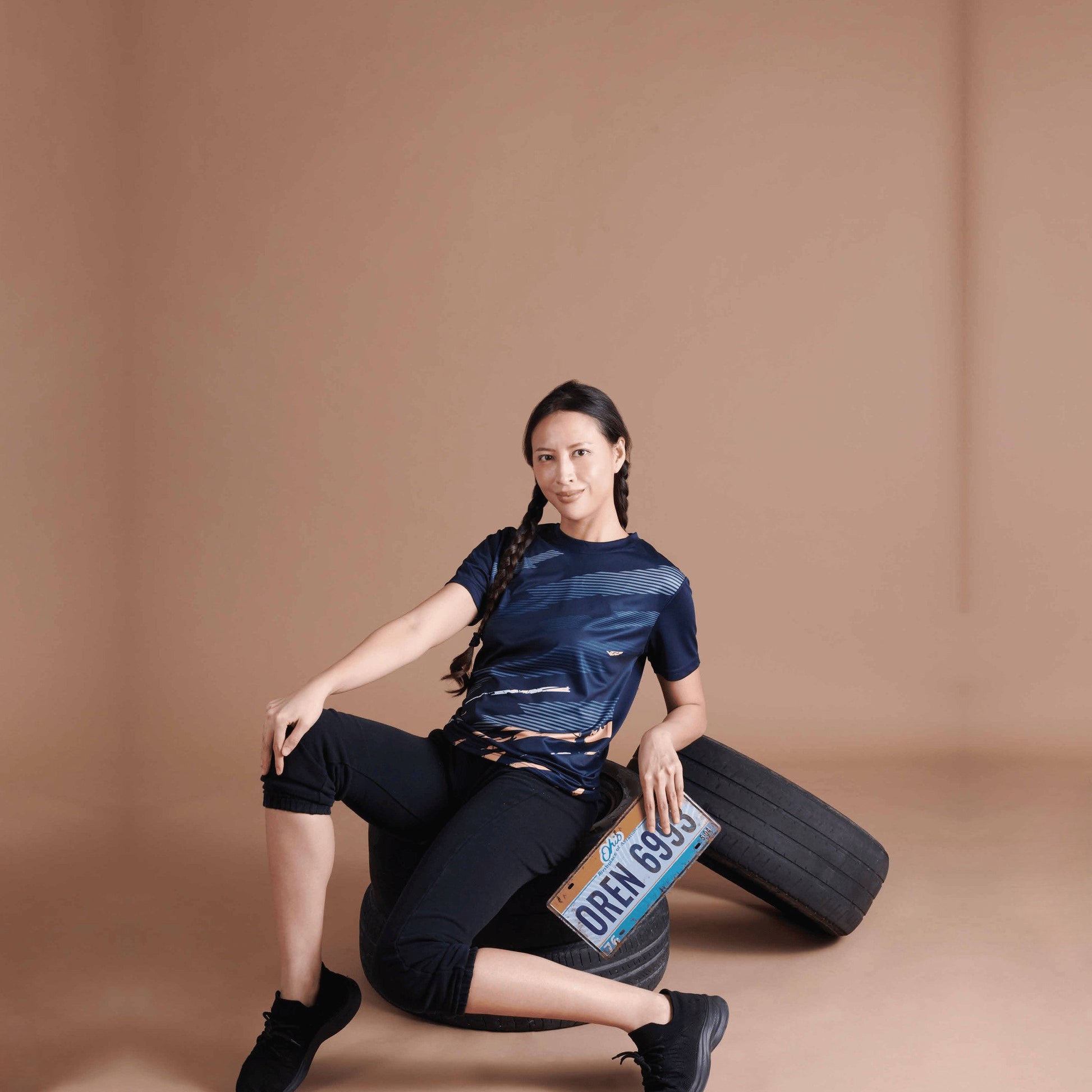 Model wearing the QD75 unisex sublimation mini eyelet t-shirt, showing the all-over printed design