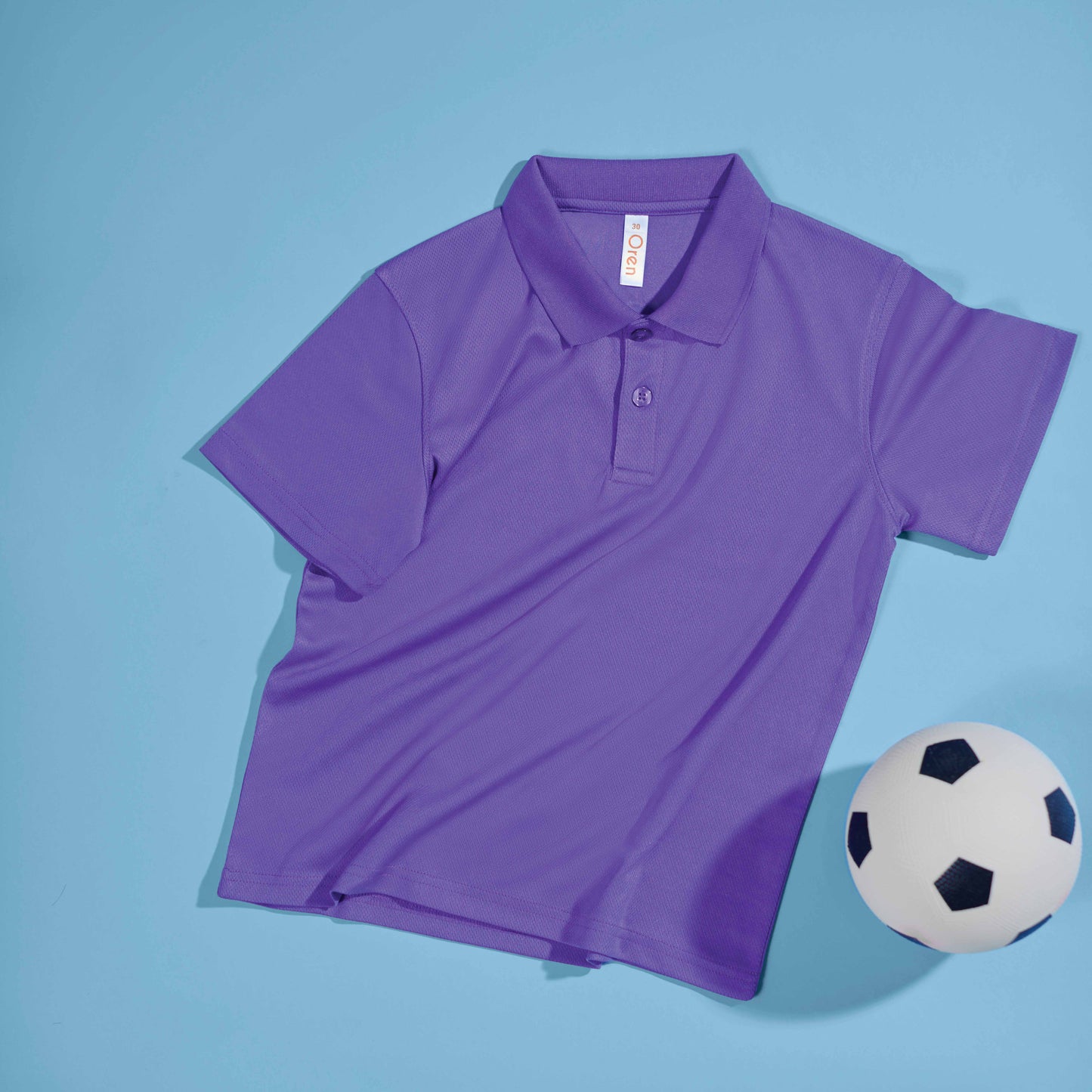 QD98 kids microfibre eyelet polo shirt flat lay in bright colours