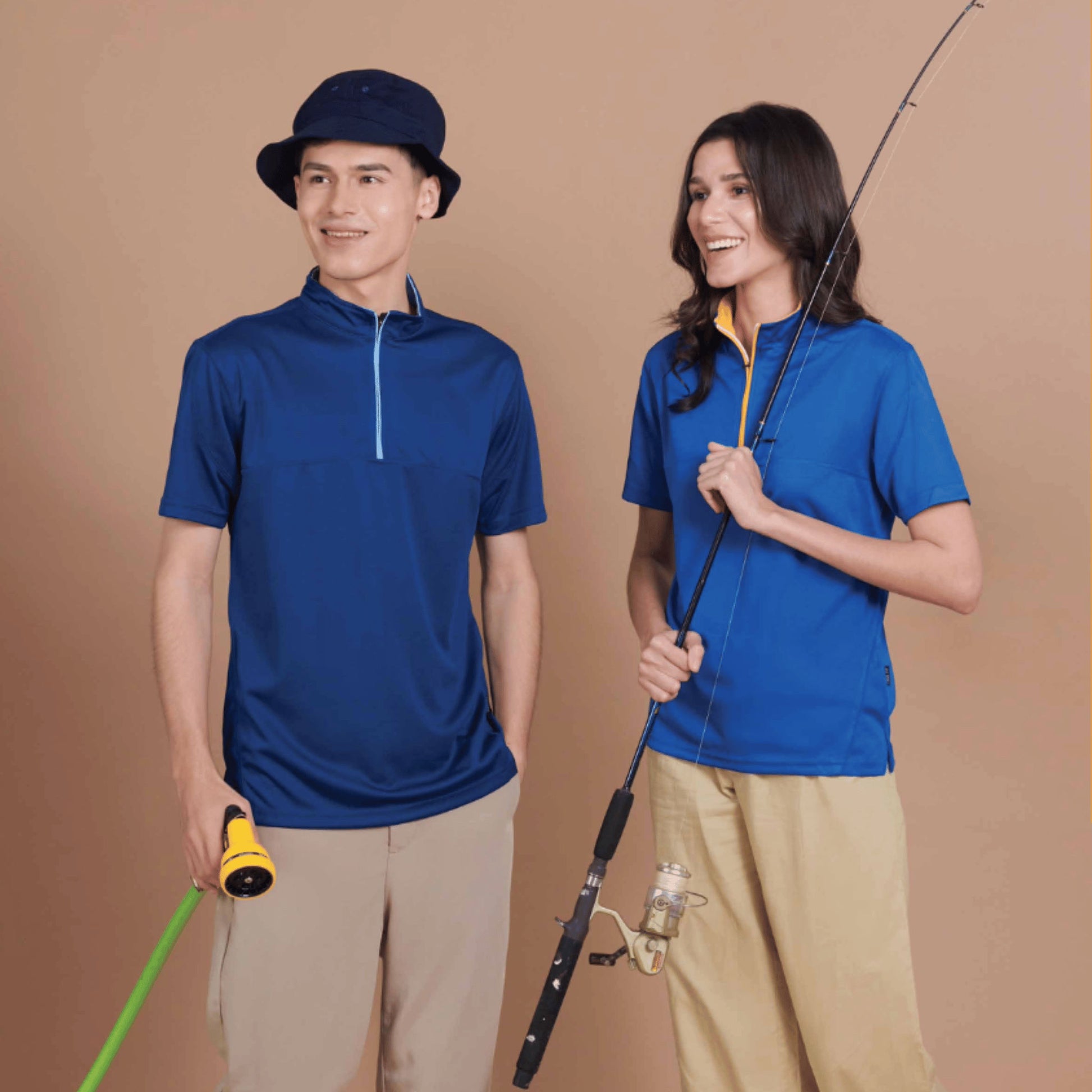 A man and a woman wearing the QD18 unisex microfibre half-zip mock neck shirt in navy pro and royal on a fishing trip, showing the contrast-colour zip placket